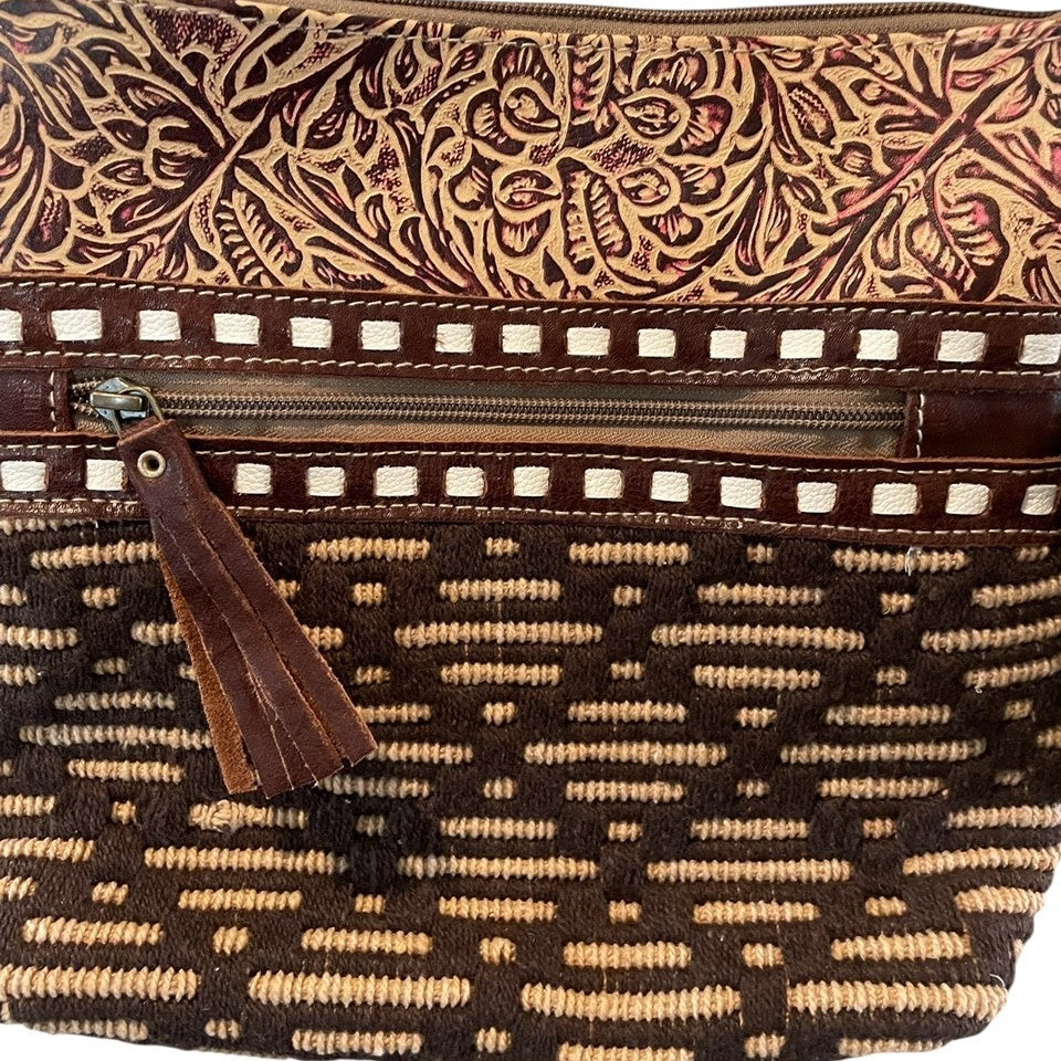 Brown patterned handbag with a tassel on a white background