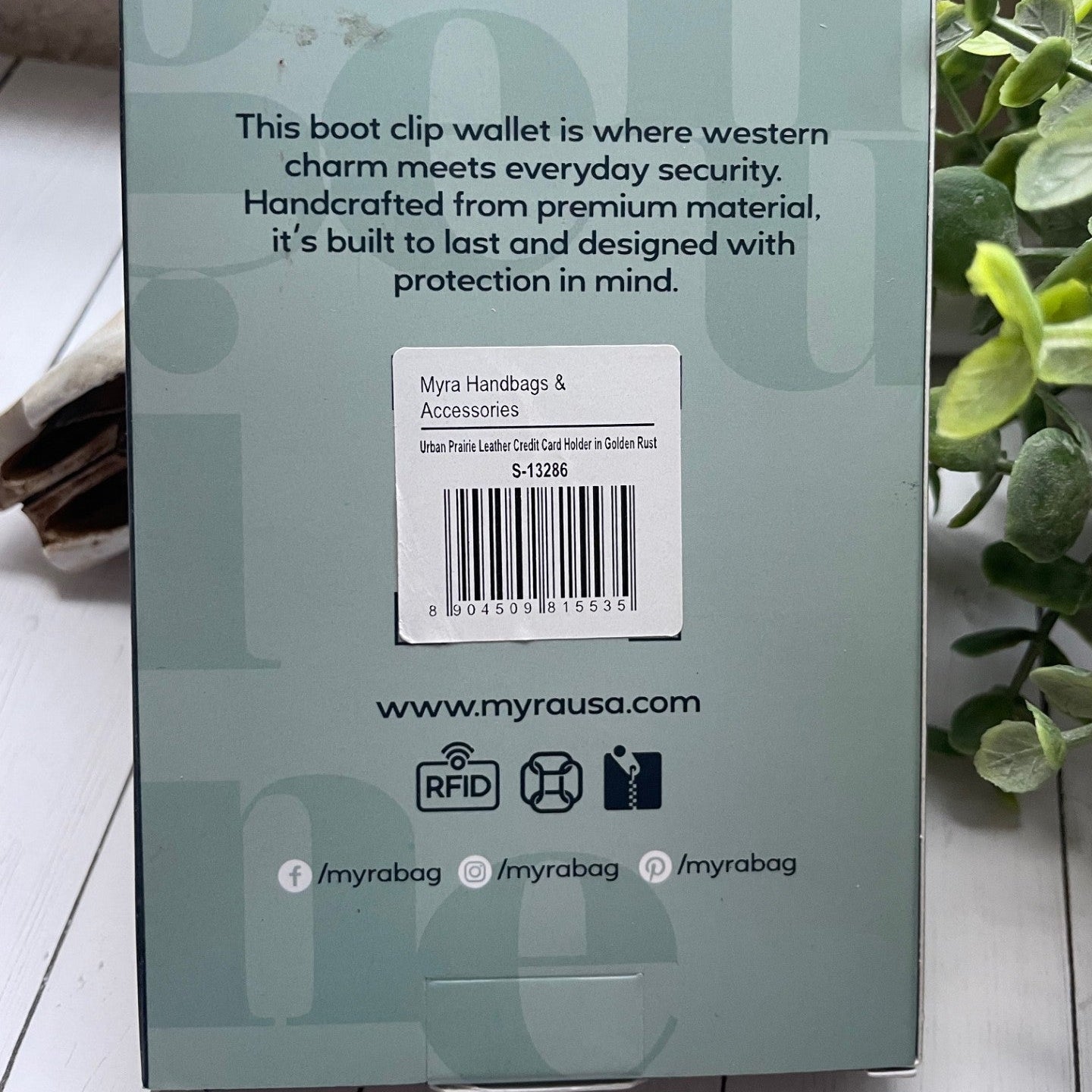 Back of a boot clip wallet packaging with text and branding.