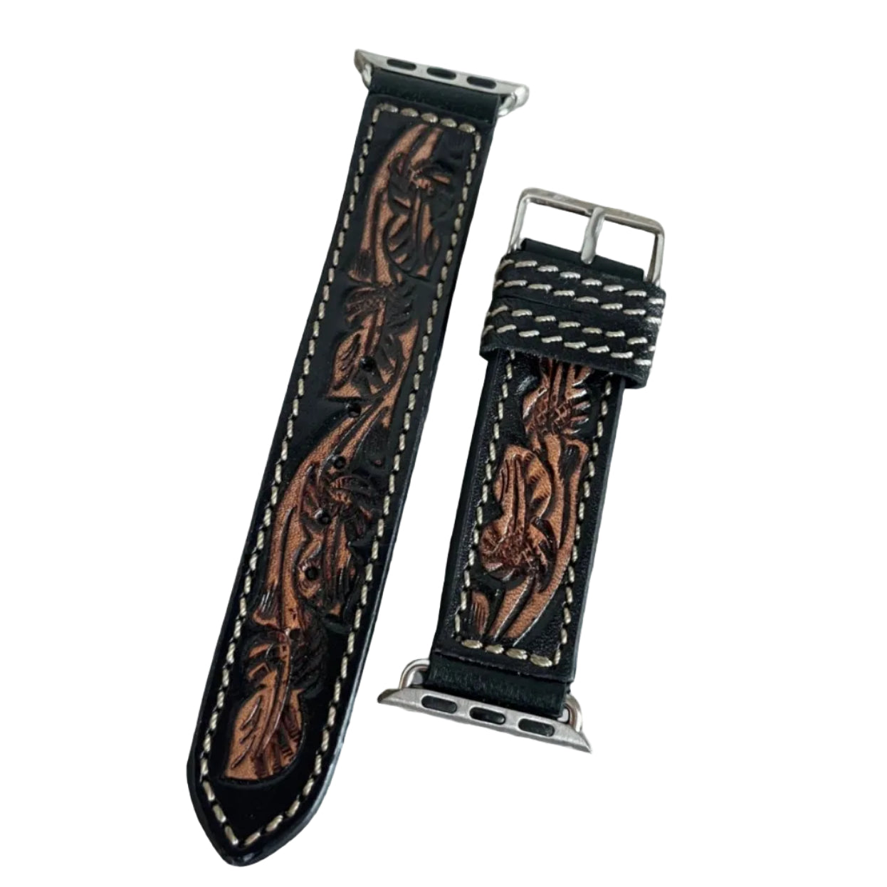 Two leather watch straps with intricate designs on a light wooden surface