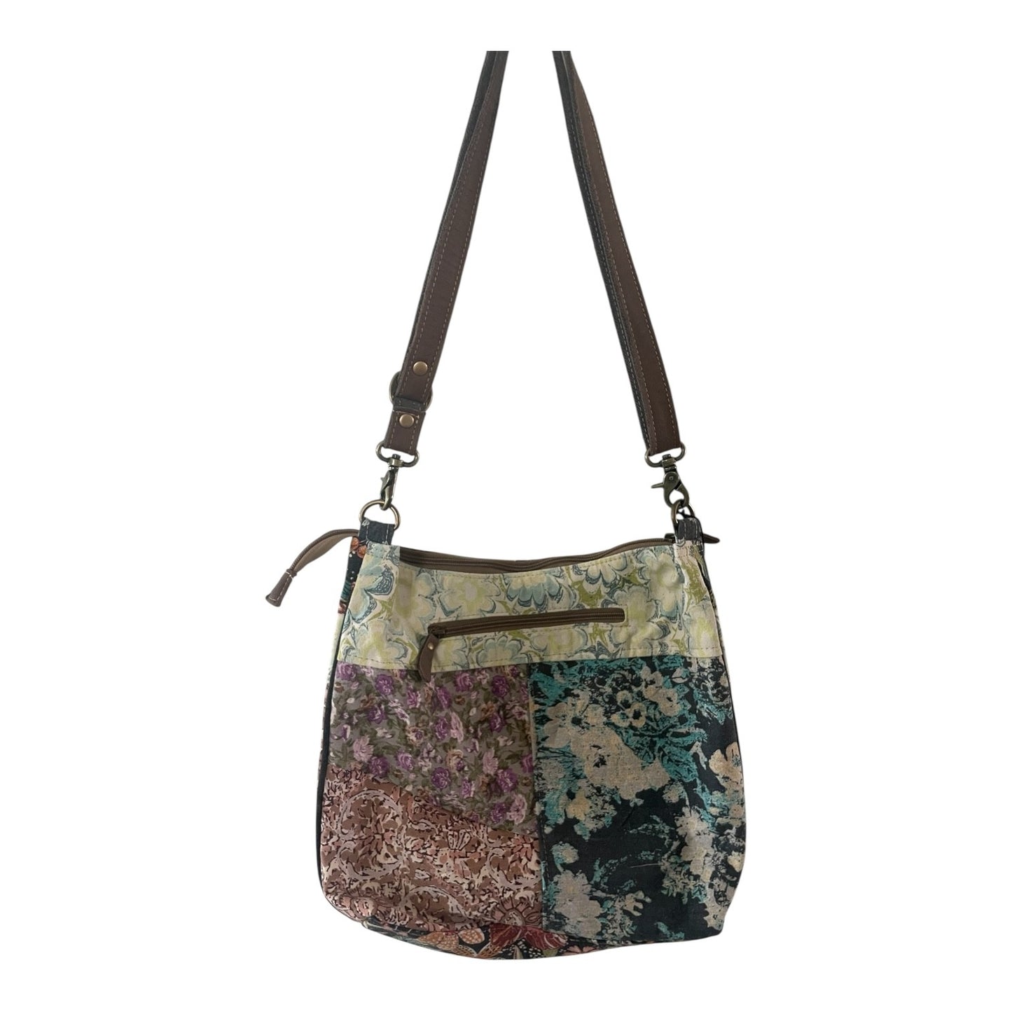 Floral patterned handbag with a strap on a white background