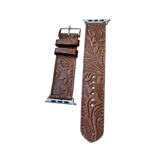 Brown leather watch strap with intricate patterns on a white background