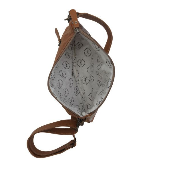 Brown leather crossbody bag with patterned interior on a white background