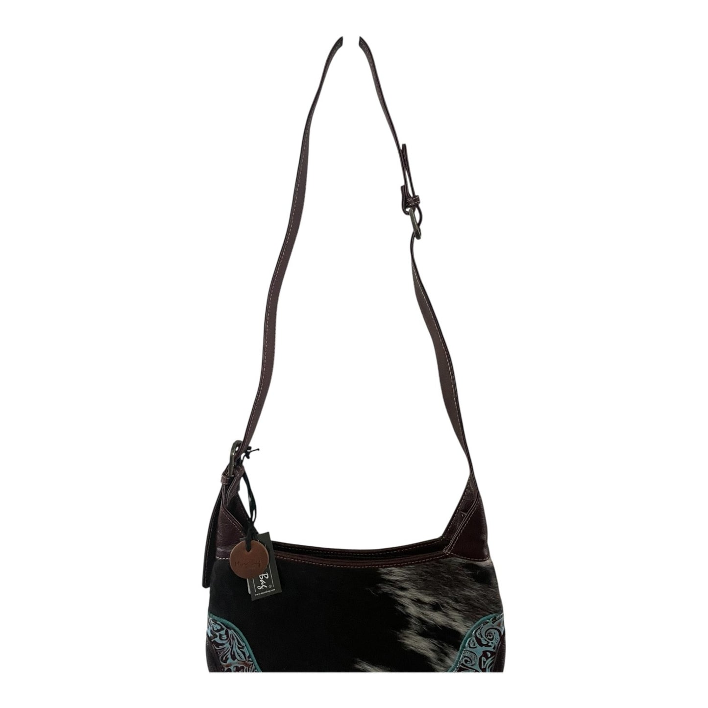 Black and brown handbag with cowhide pattern on a white background