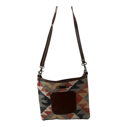 Crossbody bag with geometric pattern on a white background