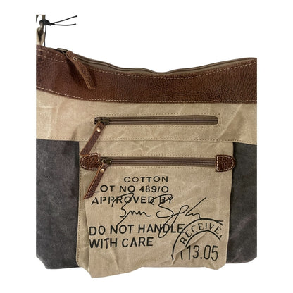 Brown and beige handbag with text on a white background