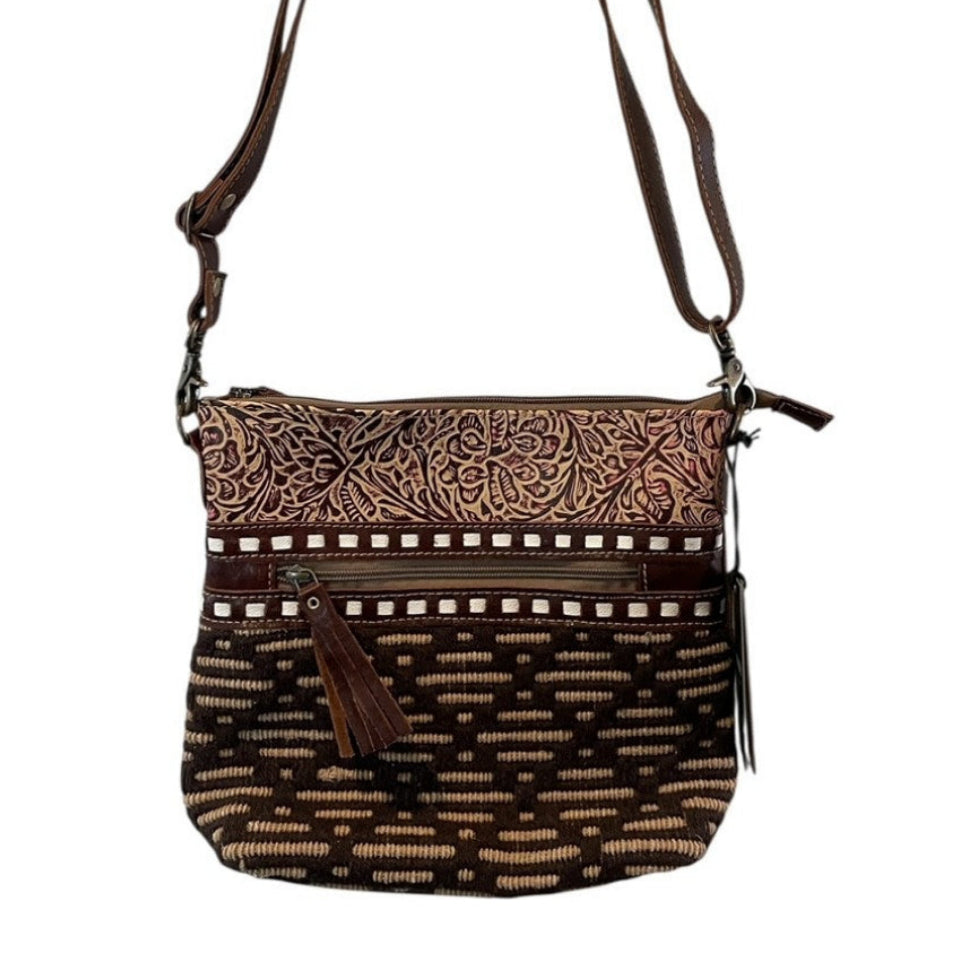 Brown patterned handbag with a strap on a white background