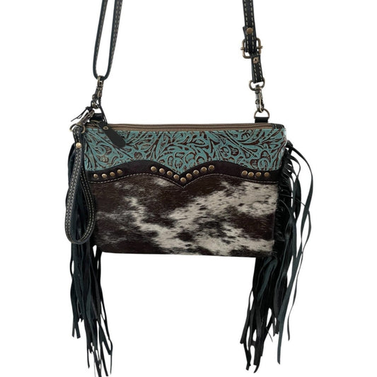 Black and white cowhide with tooled turquoise leather and black fringe on the side purse