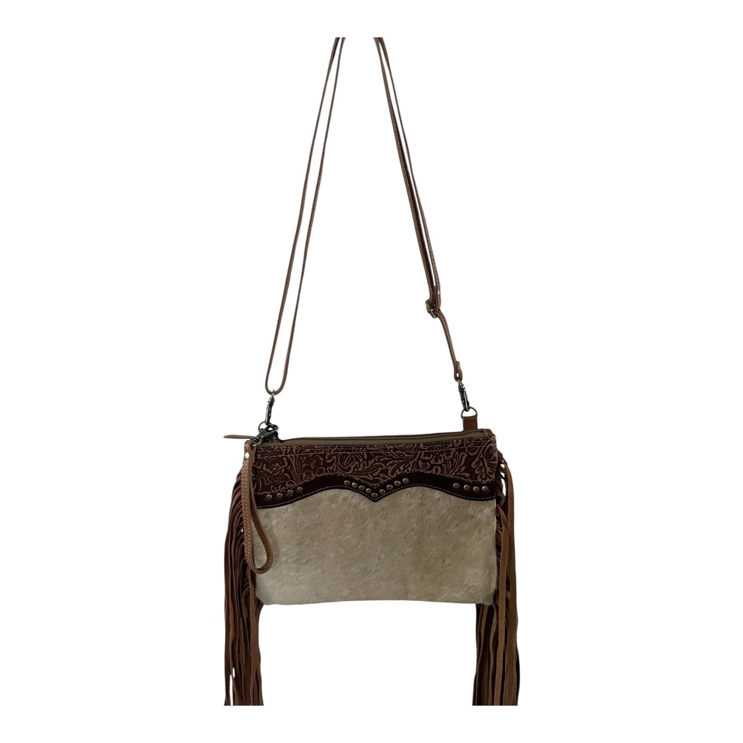 Brown and beige handbag with decorative patterns and fringes on a white background