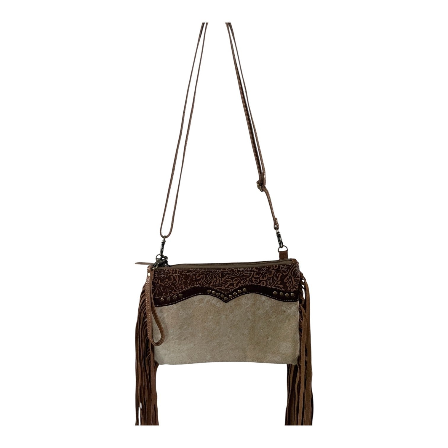 Brown and beige handbag with decorative patterns and fringes on a white background