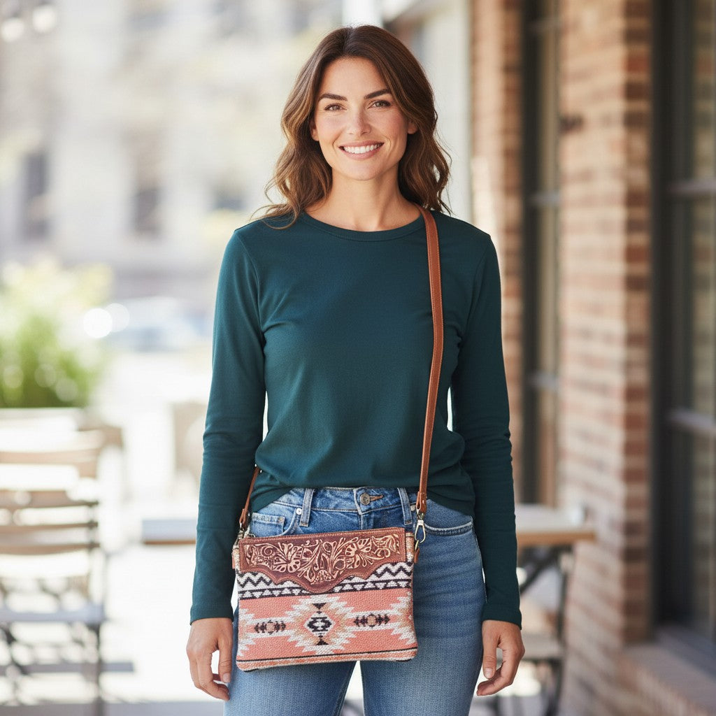 Woman holding a patterned crossbody bag outdoors