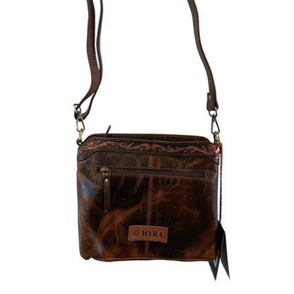 Brown leather crossbody bag with visible brand name on a white background