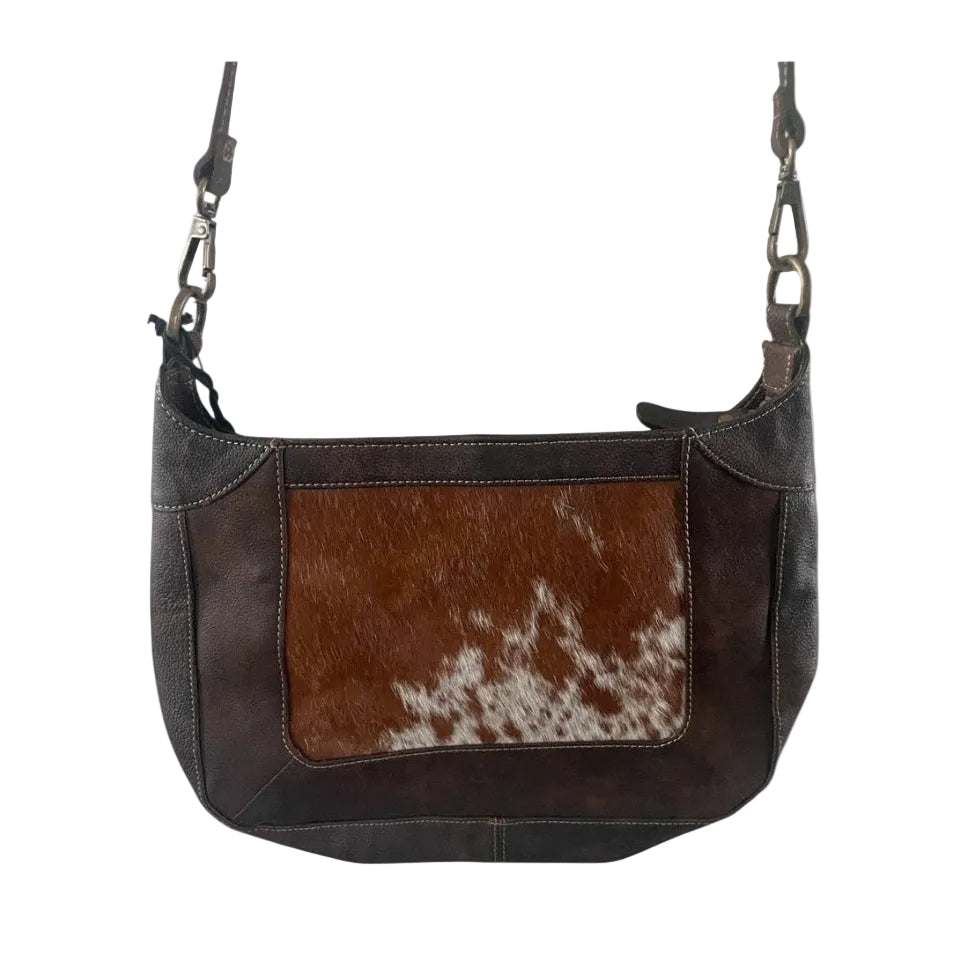 Brown leather handbag with cowhide pattern on a white background