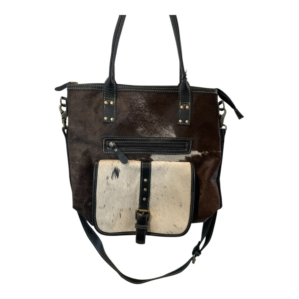 Brown leather handbag with white cowhide panel on a white background