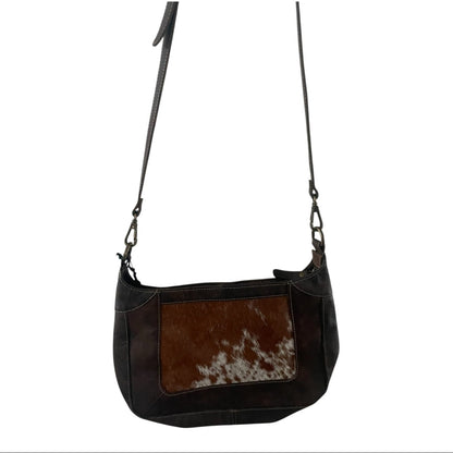 dark brown leather handbag with cowhide pattern on a white background