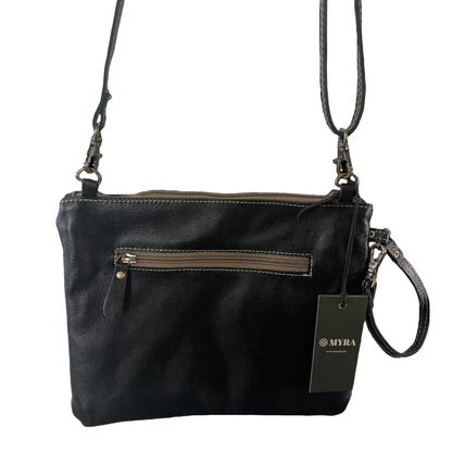 Black leather handbag with a strap on a white background, featuring the MYRA brand.