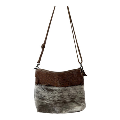 Brown leather and gray cowhide crossbody bag on a white background