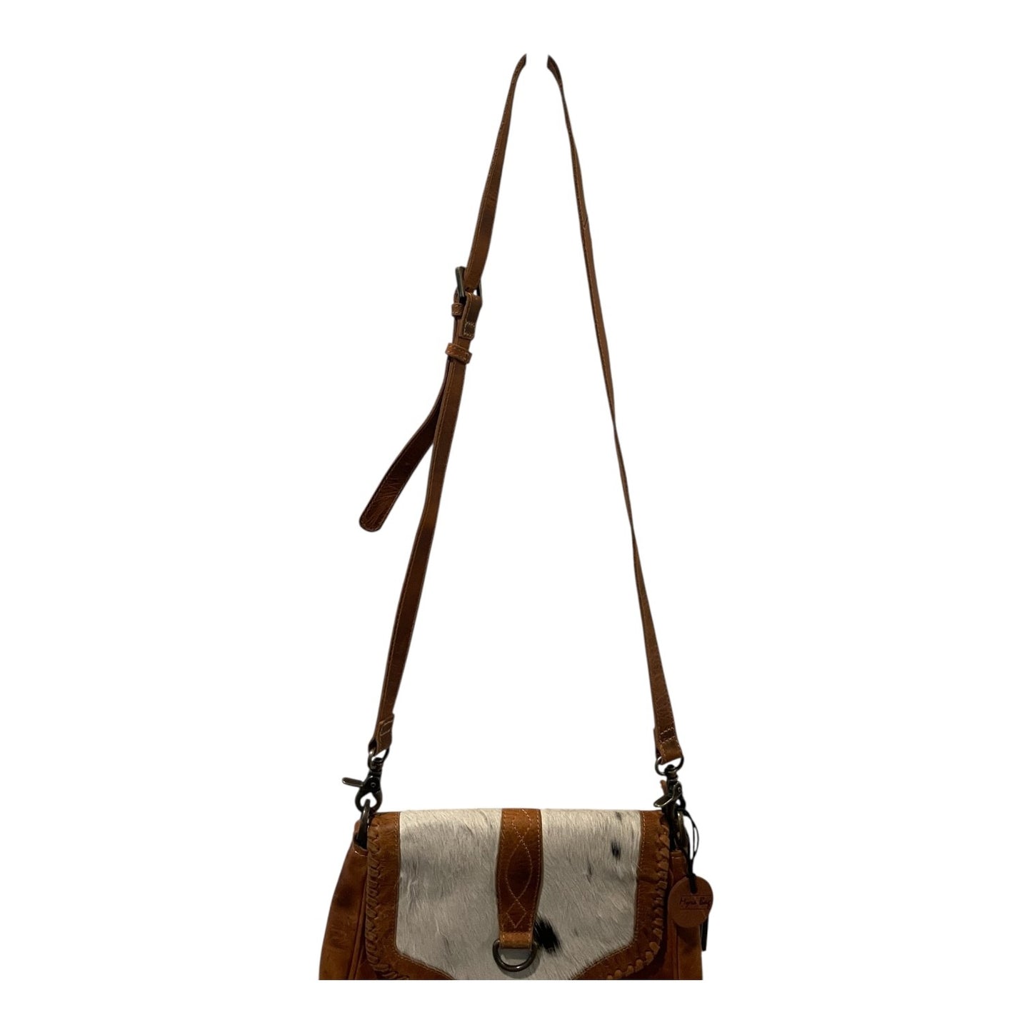 Brown and white cowhide leather handbag with a strap on a white background