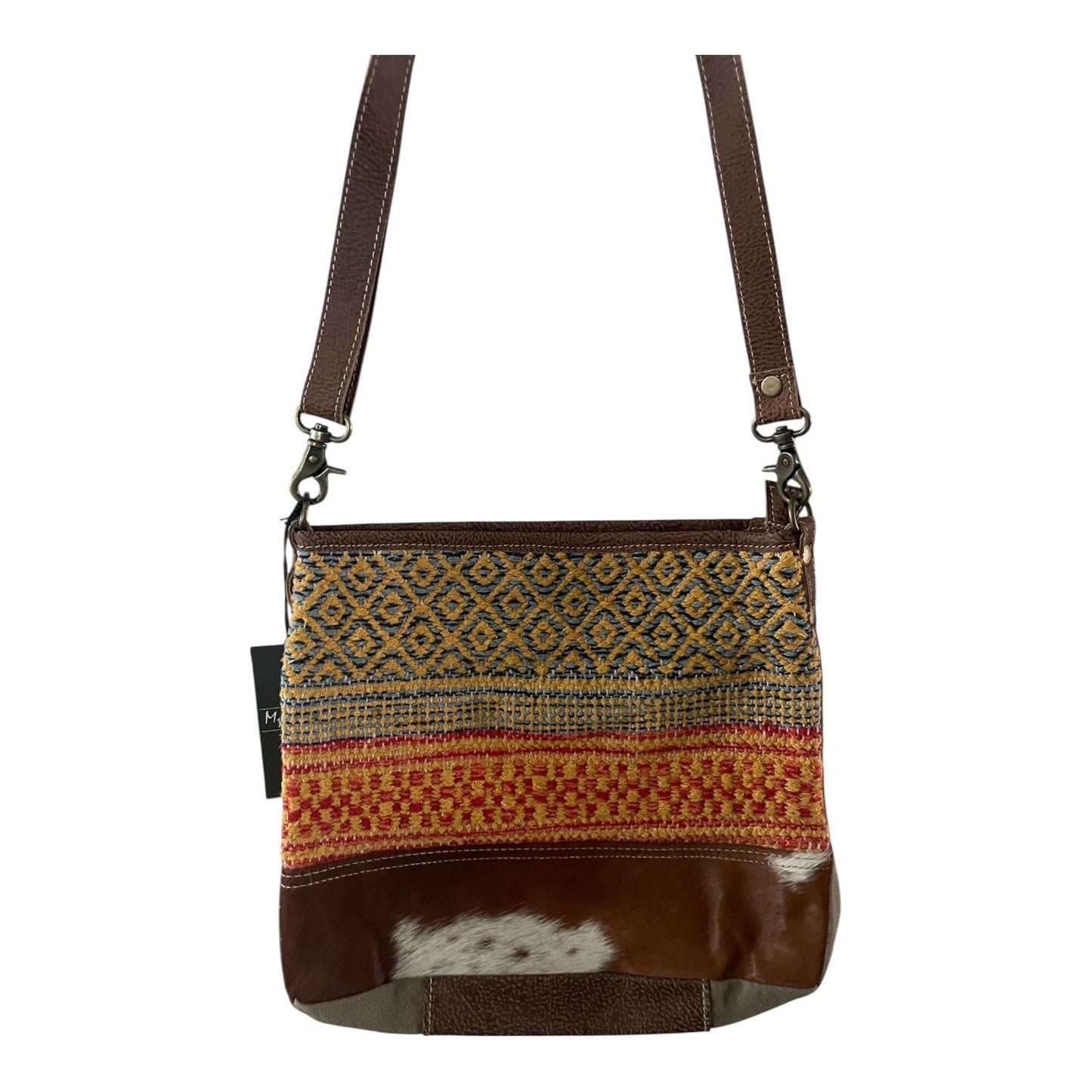 Brown crossbody bag with patterned flap and leather accents on a white background
