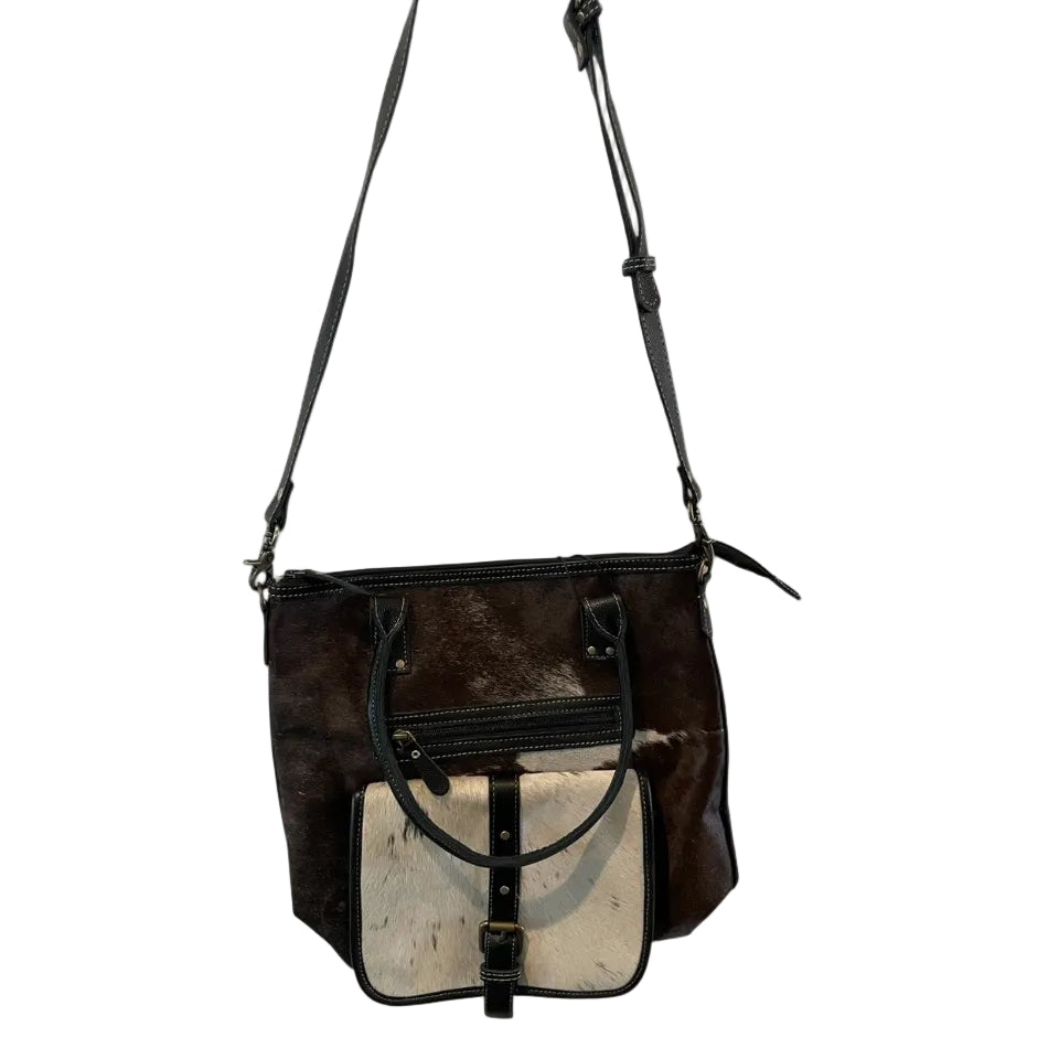 Brown leather handbag with a contrasting interior on a white background