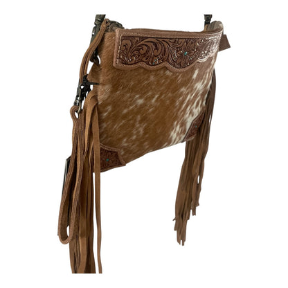A brown cowhide shoulder bag with a tooled leather flap, long brown fringe, and small turquoise accents, shown against a plain white background.