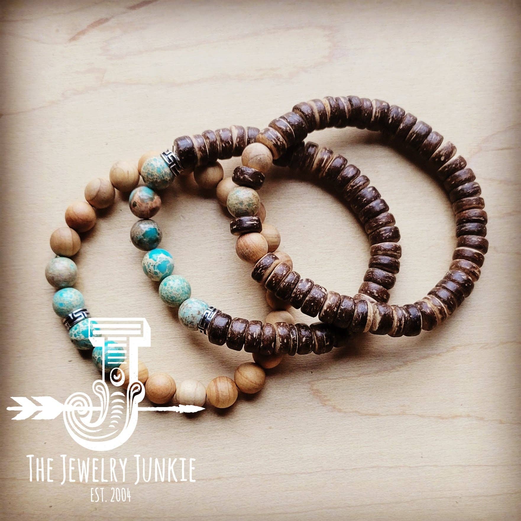 Two beaded bracelets on a wooden surface with 'The Jewelry Junkie' logo.