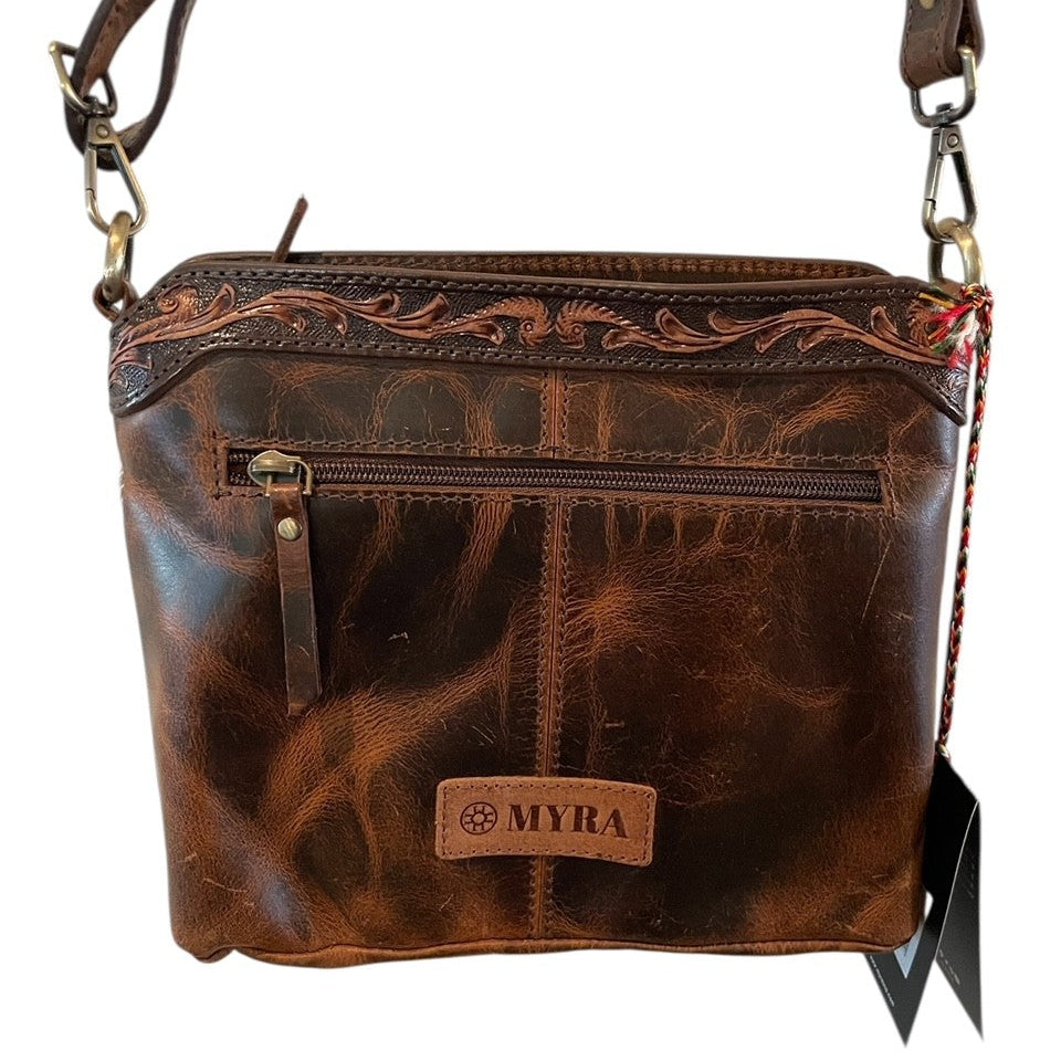 Brown leather handbag with 'MYRA' branding on a white background