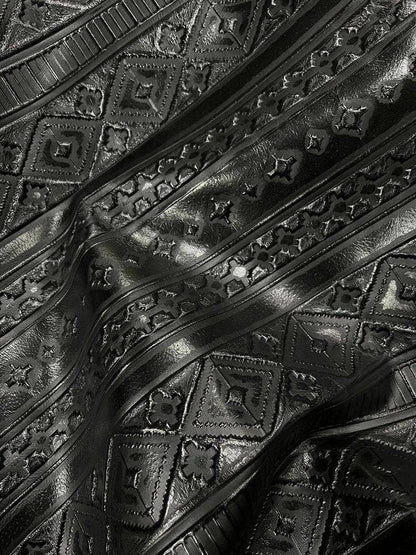 Close-up of embossed black leather with geometric patterns
