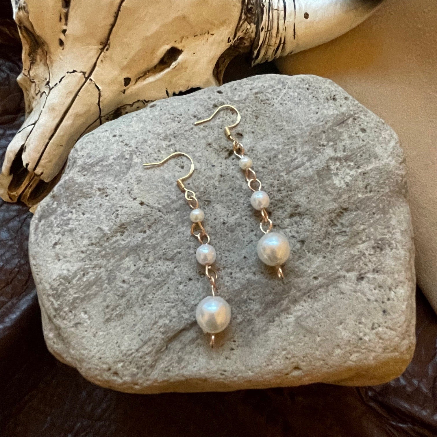minimalistic and simple, yet so pretty! Pearl beads hanging from gold ear wires, in graduated bead sizes. Perfect for so many looks. Earrings measure approximately 2.25 inches in total length,.