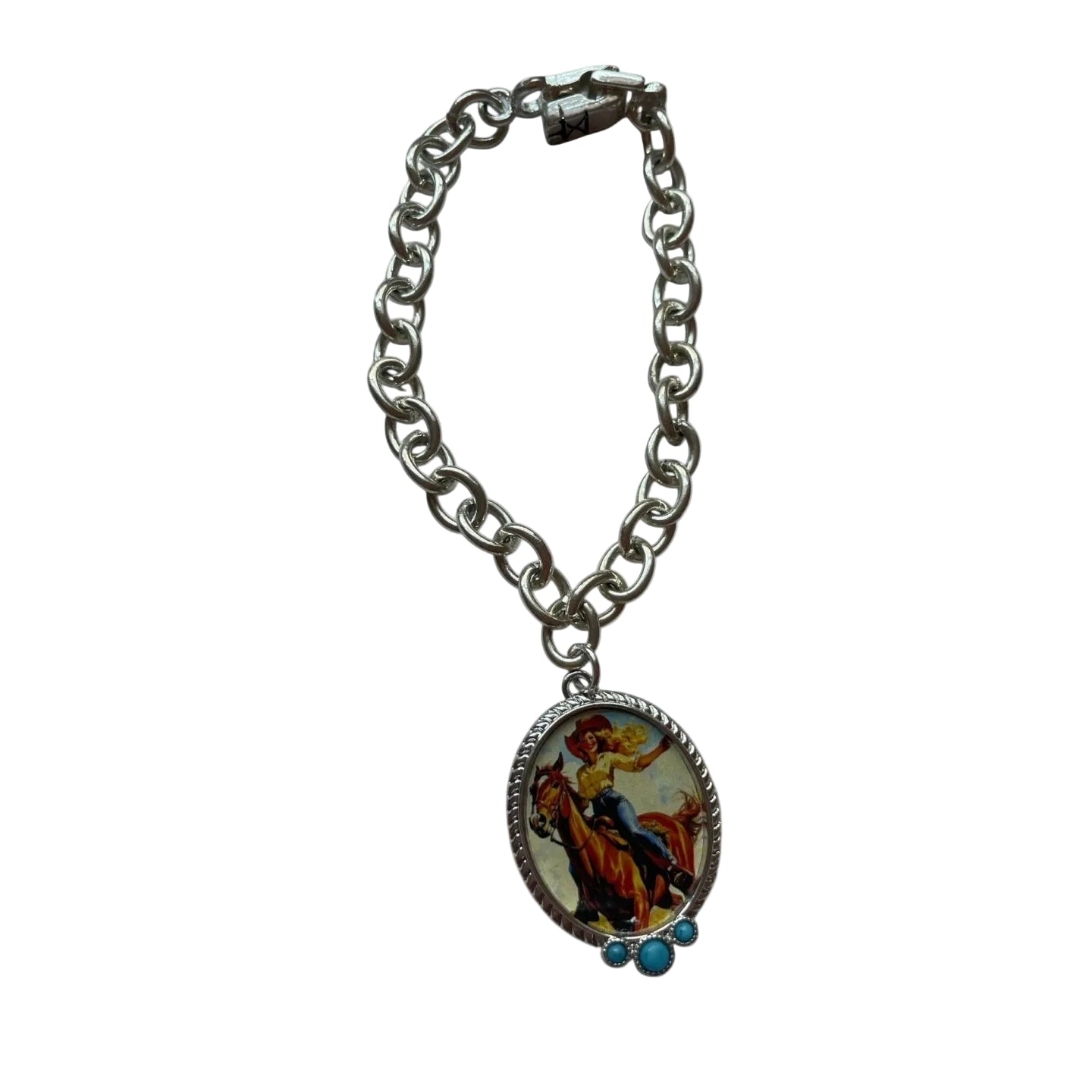 A silver-tone chain bracelet featuring an oval pendant with a colorful religious illustration of Jesus riding a donkey, accented with two small turquoise beads on the side.