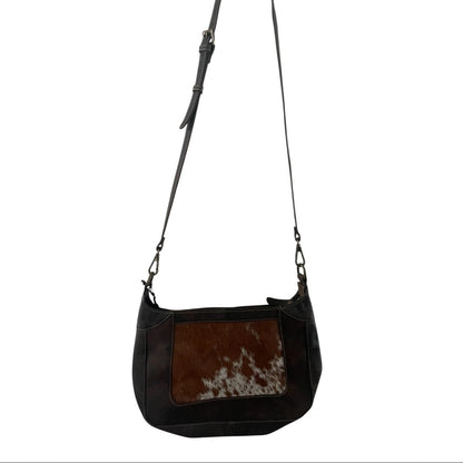 dark brown leather handbag with cowhide pattern on a white background