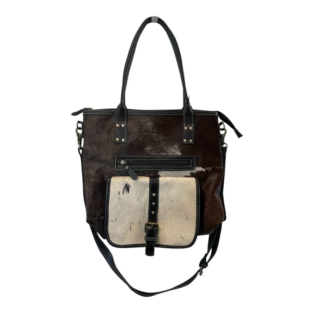 Brown and white leather handbag with black straps on a white background