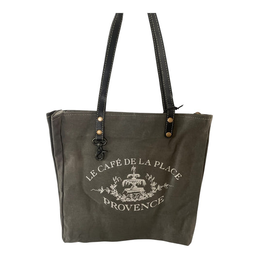Dark green tote bag with 'Le Cafe de la Place Provence' text and logo on a white background
