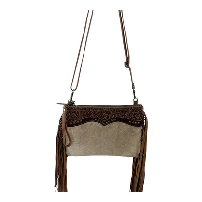 Brown and beige handbag with fringe details on a white background