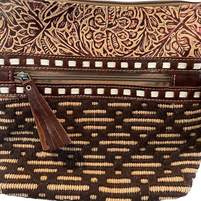 Brown patterned handbag with a tassel on a white background
