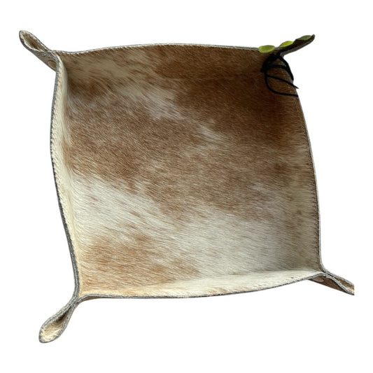Brown and white cowhide leather tray on a white background