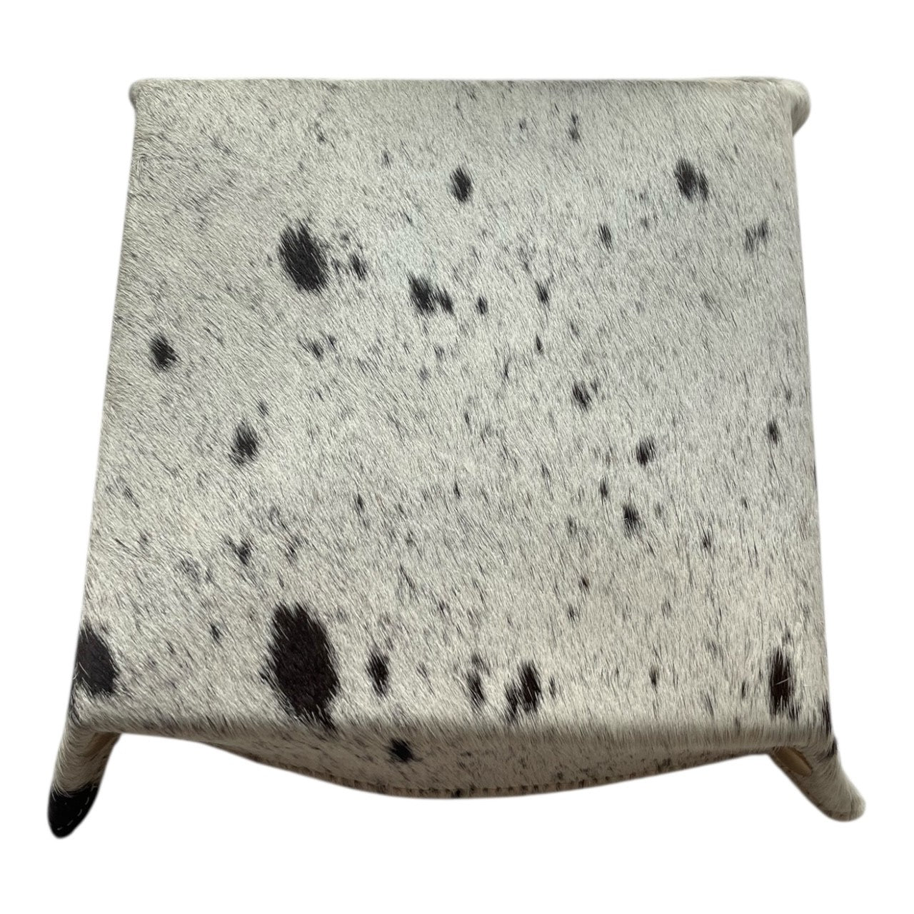 Square pillow with black spotted pattern on a white background