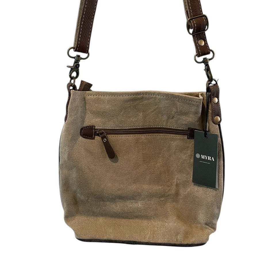Brown leather handbag with a visible brand tag on a white background