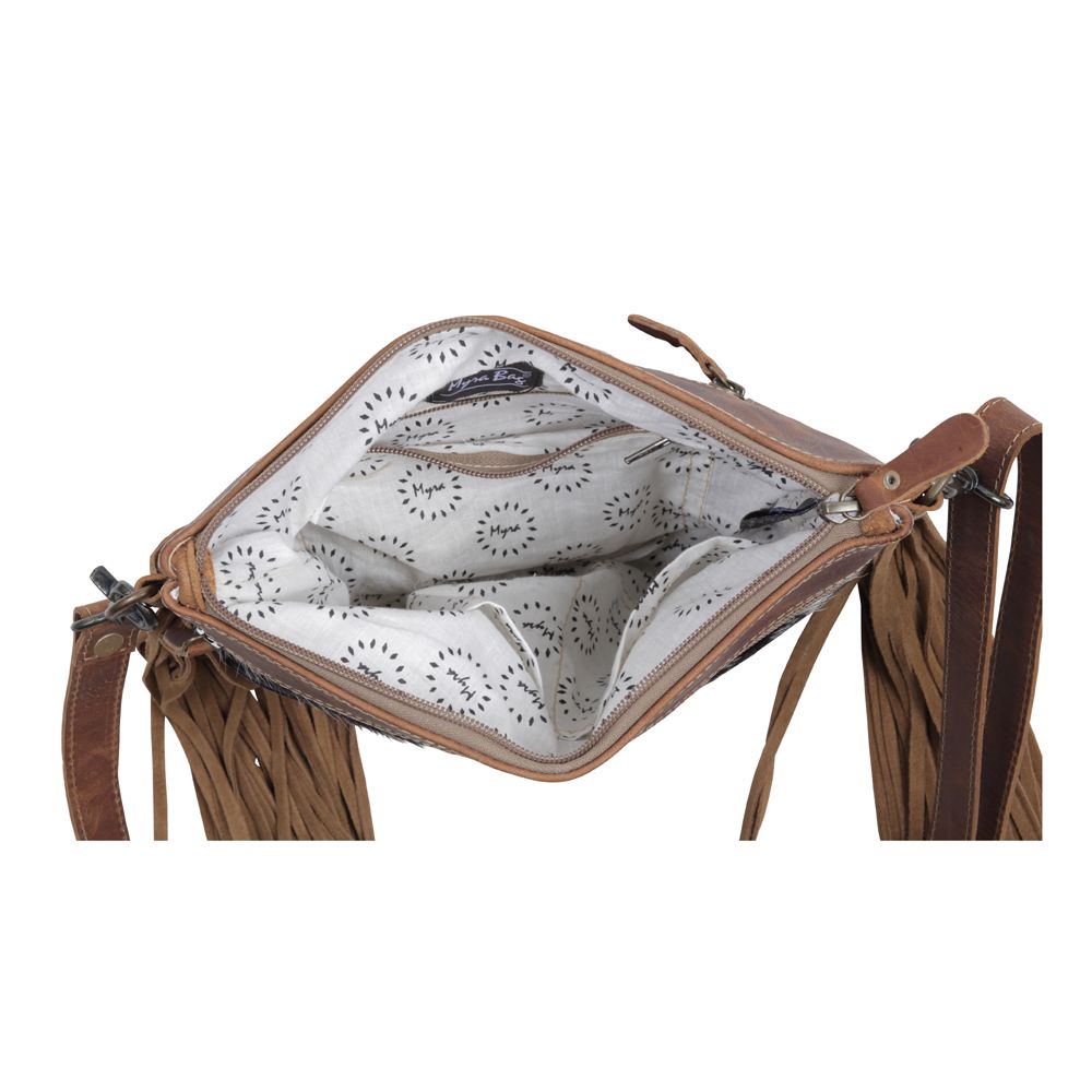 Brown leather bag with a white interior featuring black patterns on a white background