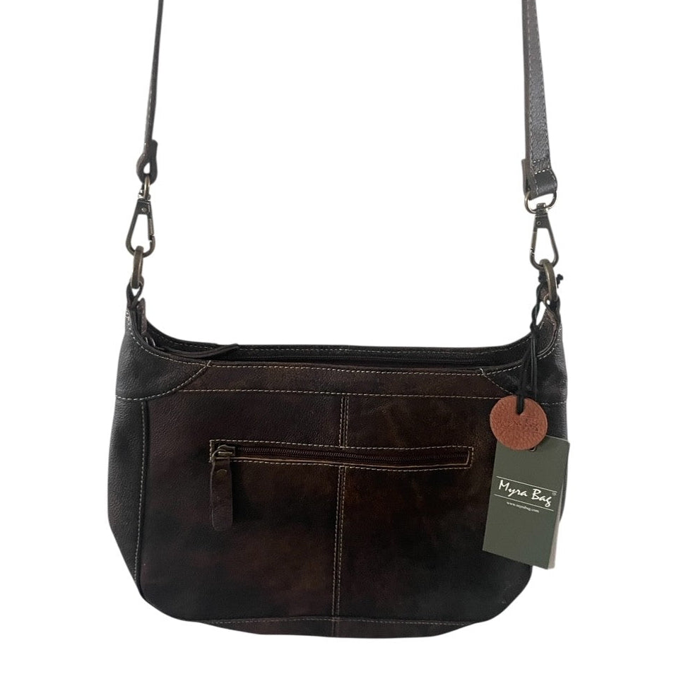 Brown leather handbag with a visible brand tag on a white background