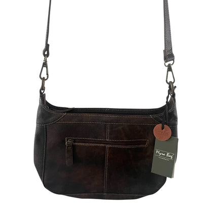 Brown leather handbag with a visible brand tag on a white background