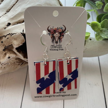 Pair of earrings with American flag design on a 'Cowgirl Trading Post' card.