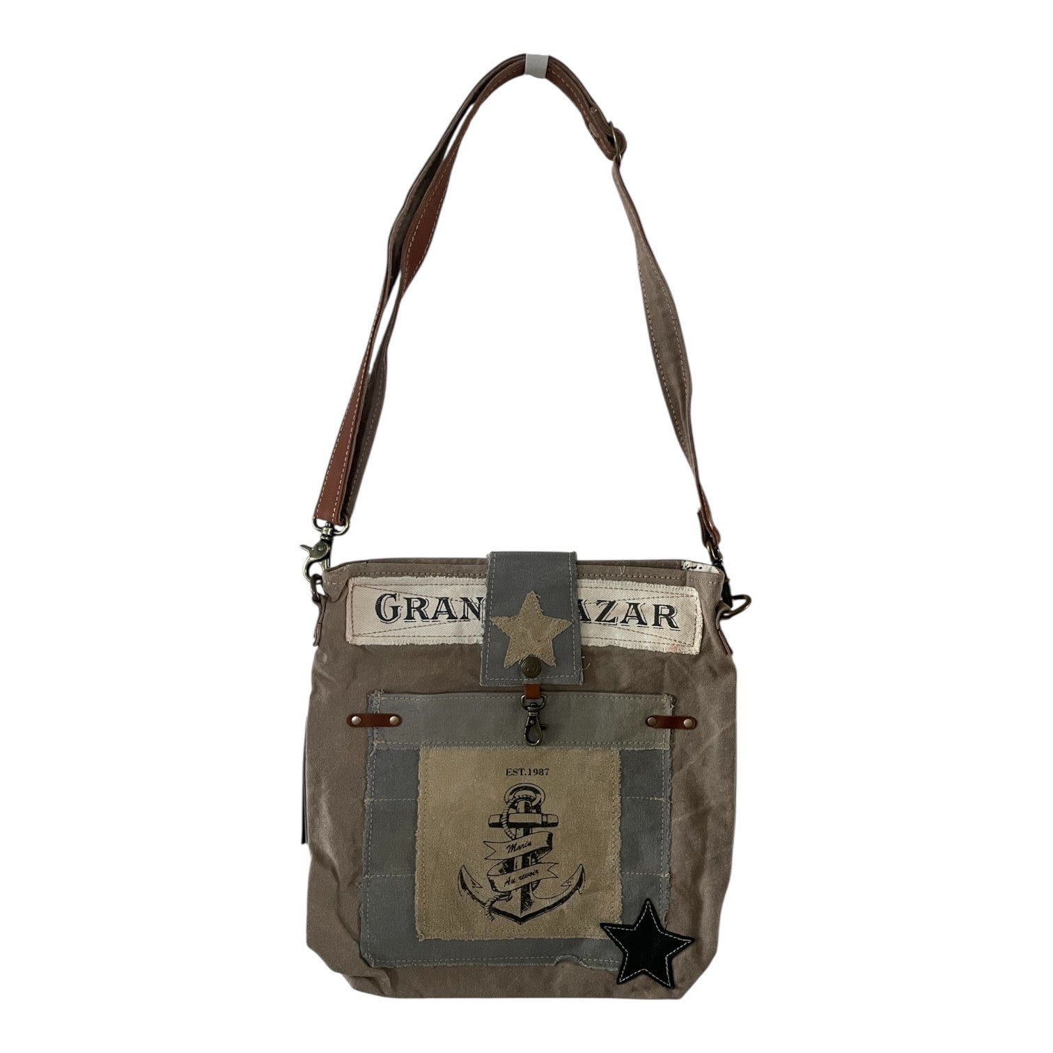 Brown leather bag with star design on a white background