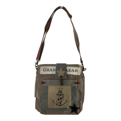 Brown leather bag with star design on a white background