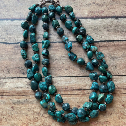 turquoise beaded necklace on a wooden surface