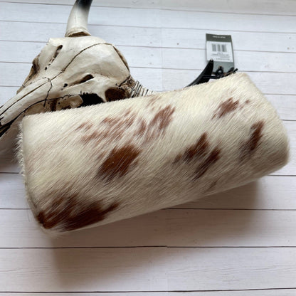 BROWN AND WHITE COHI9DE AND 
Horned animal skull with brown spots on a white surface