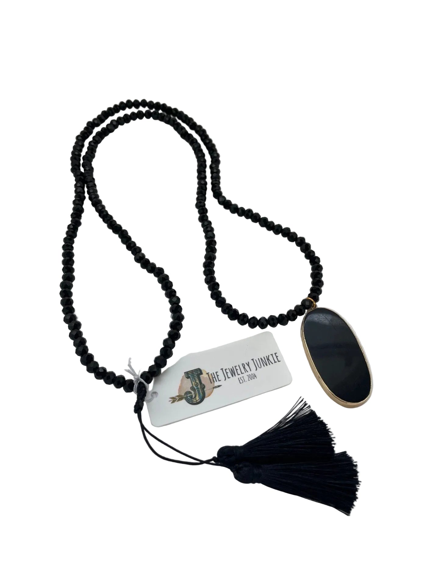 Black beaded necklace with tassel on a white background
