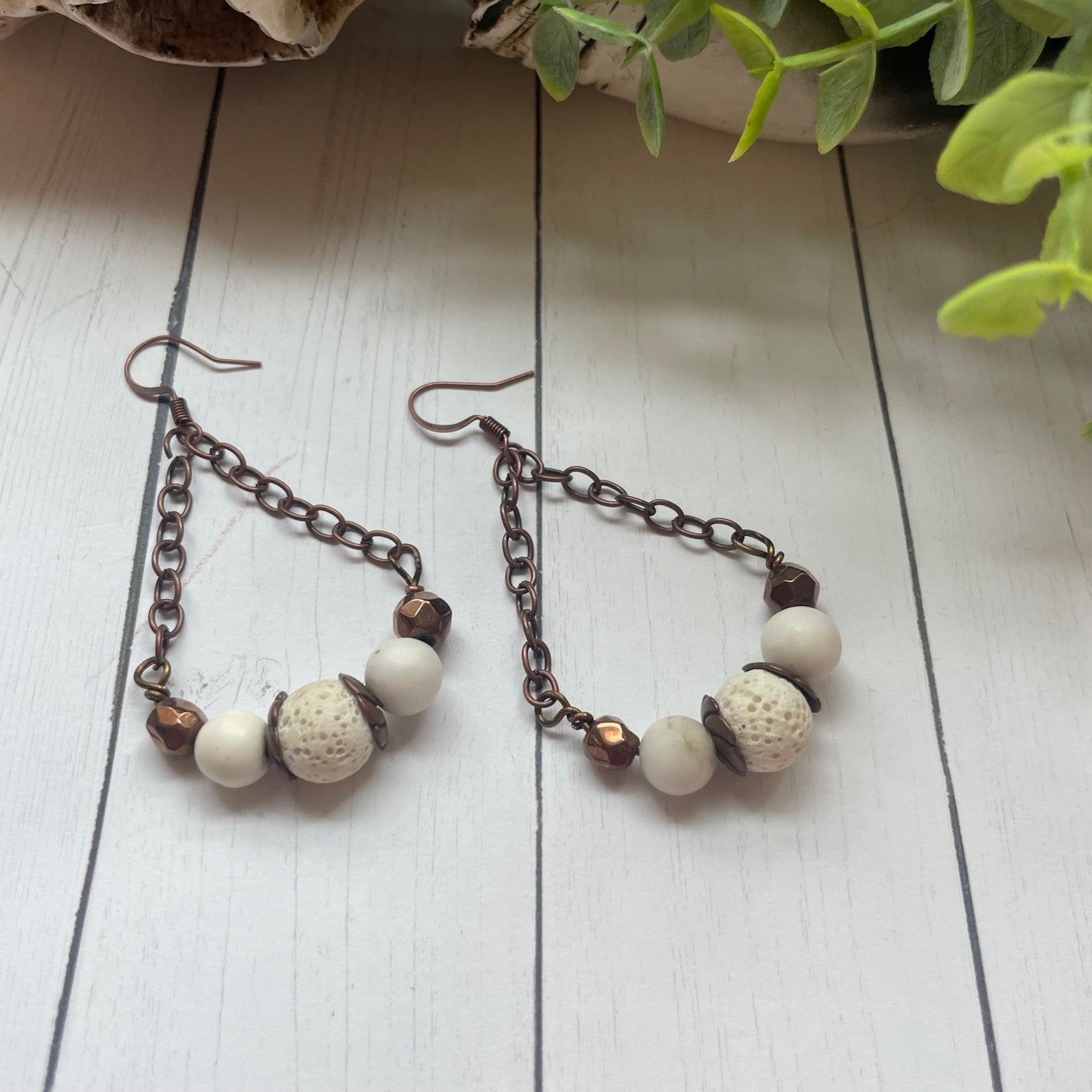Copper chain and beads and white beads with a white cow or bull skull and greenery