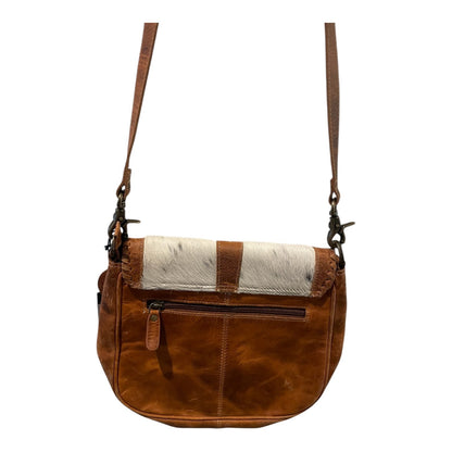 Brown leather handbag with a contrasting white and brown pattern on a white background
