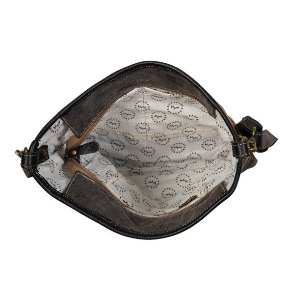 Brown leather bag with lace interior on a white background