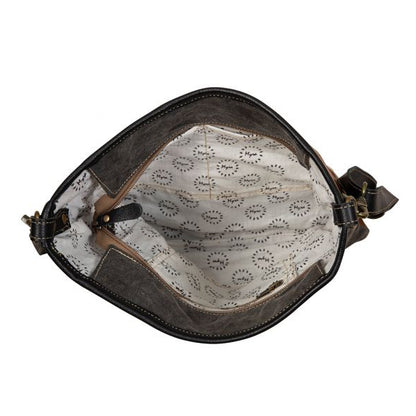 Brown leather bag with lace interior on a white background